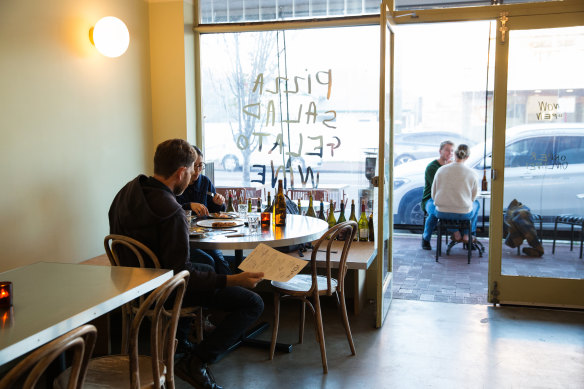 A sparse room set with tables, bentwood chairs and bench seating that speaks to designer and Casa partner Cale Mason’s less-is-more spirit.