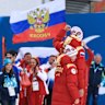 Gold medallist Anastasiia Bagiian of Team Russia and guide Sergei Siniakin celebrate to their team as they make their way to the podium during the medal ceremony for the Women’s 10km Para Cross-Country Skiing Vision Impaired race.