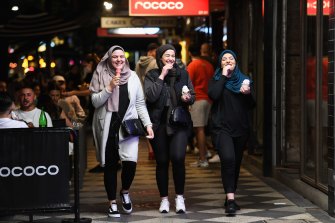 Friends reunited: Young women have a giggle and an ice-cream as they walk down St Kilda’s Acland Street.