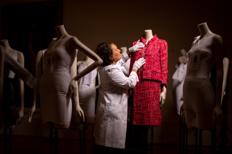 Ellen Doyle, textile display specialist, prepares a pink suit (Spring 1966) from the NGVâ€™s own collection for the upcoming exhibition, Gabrielle Chanel. Fashion Manifesto.