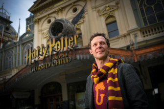 Actor Gareth Reeves in his Harry Potter scarf in front of the Princess Theatre.
