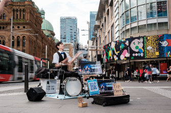 Kaisei Nakamura busks under the name Gaku at George and Park St Sydney CBD to make money in an increasingly cashless world.