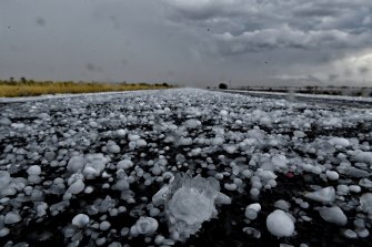 Giant hail covers the road north of Bourke as storms sweep through the region