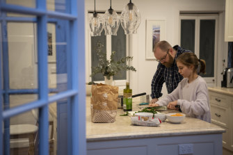 Ian Davidson prepares dinner from a meal kit with his 11-year-old daughter Nimue.