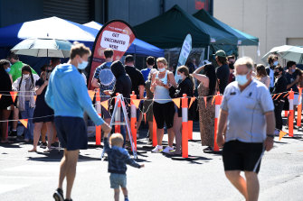 People queue to receive a COVID-19 vaccine at Bunnings in Brisbane last month.