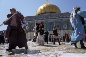 Palestinian volunteers clean the Al-Aqsa Mosque compound, in front of the Dome of Rock Mosque, ahead of the Muslims holy month of Ramadan, in Jerusalem’s Old City.