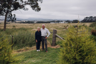 Bev and Graham Hordern at home in Moss Vale. Over their shoulder is the site of what may become the nation’s largest plastic recycling facility.