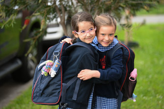 Brunswick prep students Eleni (left) and Zara embrace as they return to school on Monday morning after 74 days of remote learning.