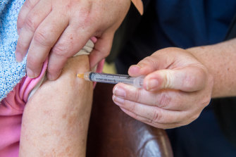 A Melbourne GP administering a COVID-19 vaccine earlier this year. 