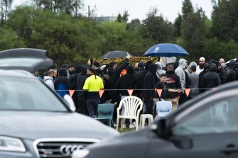 Mouners watch as Mahmoud “Brownie” Ahmad’s body is laid to rest at Rookwood Cemetery after a service at Lakemba Mosque on Saturday.