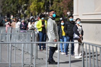 People queue at the Royal Exhibition Building vaccination centre in Carlton on Saturday.