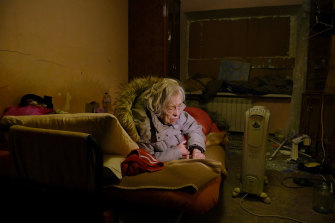 Unable to walk, Galyna Rasstanna, 86, lies in her bed and weeps and begs for the shelling to stop. 