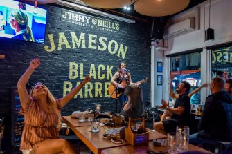 Patrons at St Kilda bar Jimmy O’Neill’s enjoy the live music.