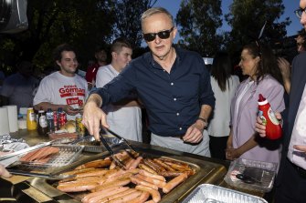 Opposition Leader Anthony Albanese cooks sausages at an event with Labor supporters at Altone Park in the seat of Cowan, in Perth.