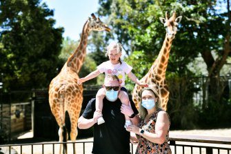 A family visiting the giraffe exhibit at Melbourne Zoo last year. 