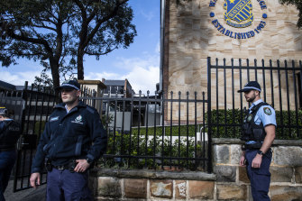 Police monitor the evacuation at Waverley College.