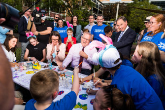 Five-year-old Kieran Delaney, centre front, nominates retiring minister Greg Hunt as his pick to win the coming election.