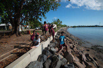 Children playing on the already breached sea wall on Saibai Island.