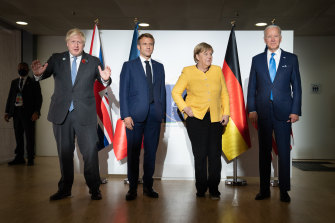 British Prime Minister Boris Johnson, French President Emmanuel Macron, German Chancellor Angela Merkel, and U.S. President Joe Biden, pose for the media prior to a meeting at the La Nuvola conference center for the G20 summit. 