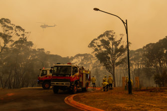 Firefighters conduct backburning operations ahead of deteriorating conditions in Hill Top, NSW.