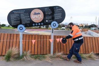 A council worker closes the Elwood skate park due to the tougher COVID-19 lockdown rules.