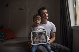 Nicholas Kelly and his son Xander holding a photo of Nicole, who died January 2 after being diagnosed with stage 4 adenoid cystic carcinoma in 2018. 
