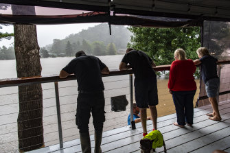 Caravan owners gather to survey the carnage on the river.