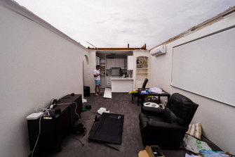 Dee Why resident Nathan Lavers in his unit on Pacific Parade, Dee Why, whose roof was ripped off during the  “microburst” , a severe storm downdraft often with winds exceeding 100kph.  