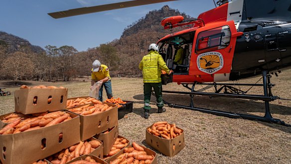 A National Parks and Wildlife Service helicopter prepares for the food drop.