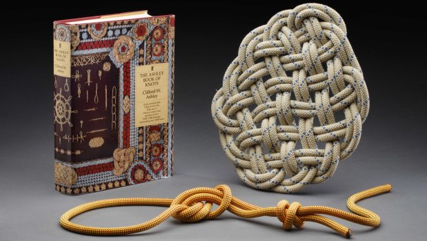 Craig Challen's The Ashley Book of Knots, and a knotted rope and large flat knot. 
