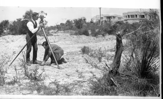 Surveyor with theodolite in early days of Castlecrag development.