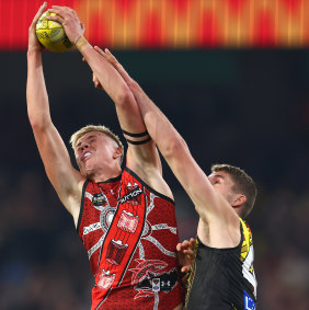 Nate Caddy of the Bombers marks in front of Tiger Ben Miller.