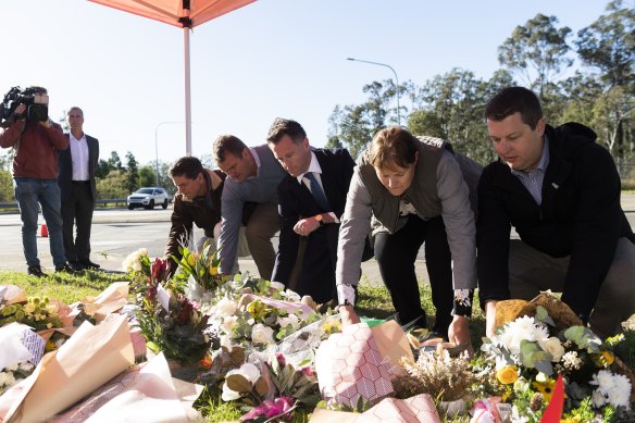 NSW Premier Chris Minns (centre) lays a wreath at the public memorial of the Greta bus crash. 