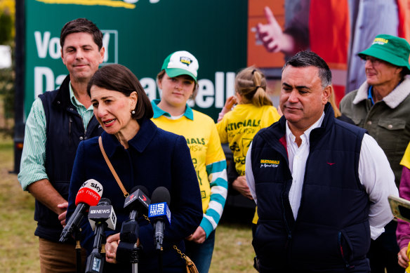 NSW Premier Gladys Berejiklian is flanked by Nationals candidate Dave Layzell and Deputy Premier John Barilaro at a press conference in Muswellbrook on Saturday.