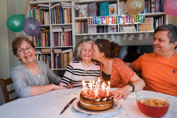 Cake, candles and kisses: Carolyn Paynting kisses her Mum Rose as the family, including sister Lynette James, left, and Carolyn’s husband Salvatore Turco, reunite for Rose’s 89th birthday. 