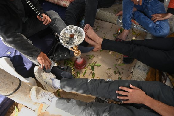 Afraid to show faces, fearful of what comes next: some of the Gazans in the Ramallah Recreational Complex.