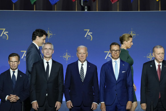 President Joe Biden (centre) stands as others arrive during an event commemorating the 75th anniversary of NATO at the Andrew W. Mellon Auditorium on the sidelines of the NATO summit in Washington.