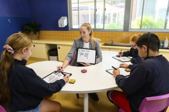 Teacher Elise Mountford with year 6 Charlestown South Public students.