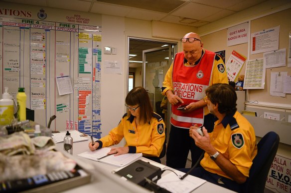 Operations Manager Ken Hall (red bib) talks to his team as they prepare for Saturday's potentially catastrophic fire conditions.
