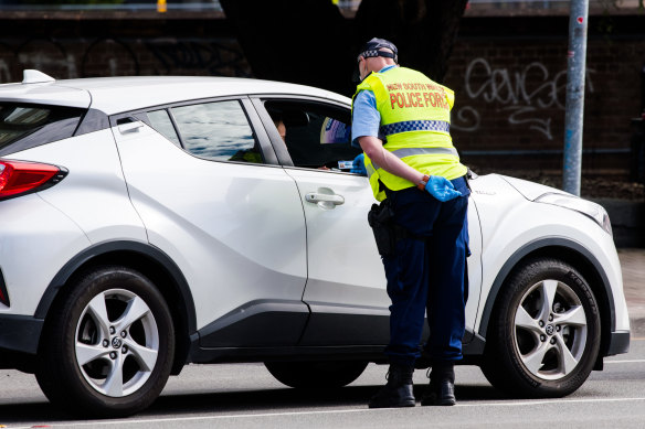Police speak to a driver at a checkpoint on the Princes Highway when a CBD exclusion zone applied last month.