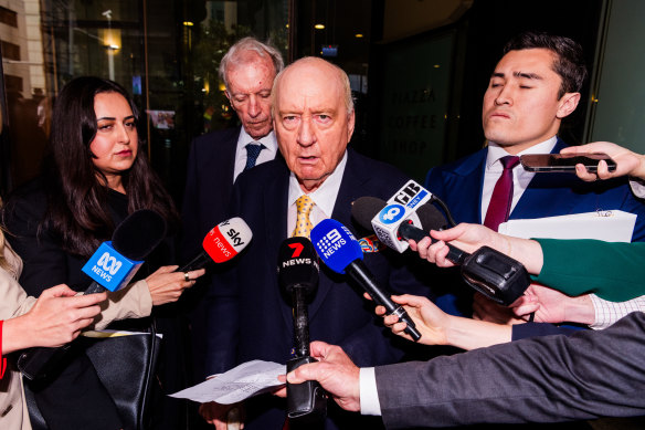 Jones faces the media scrum.