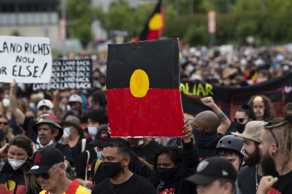 The protesters marched from the city centre to the lawns of Old Parliament House.