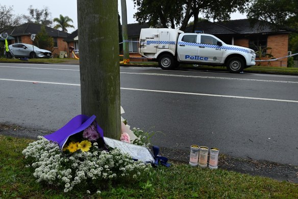 Candle and flower tributes have been placed around a power pole in Freeman Street, Lalor Park, for the three children killed in an alleged domestic homicide.