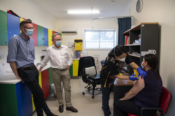 Carly Fernando receives her COVID-19 booster vaccination while Dominic Perrottet and Minister for Indigenous Affairs Ben Franklin visit Coonamble Aboriginal Health Service.