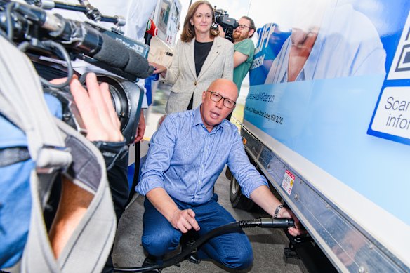 Peter Dutton fills up during one of more than a dozen petrol-pump photo opportunities to promote his temporary fuel excise cut. 