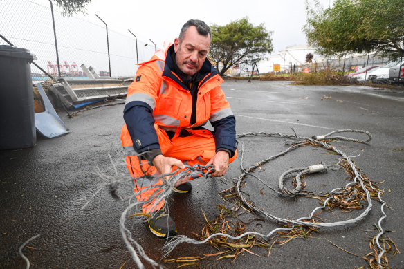 Tug crewman Troy Bovill with one of the snapped cables from the rescue. 