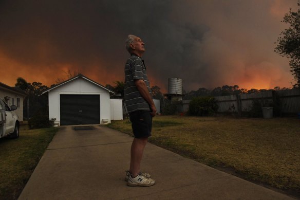 Geoff Gardener watches the fire approach his home at Silverdale Road in Orangeville.