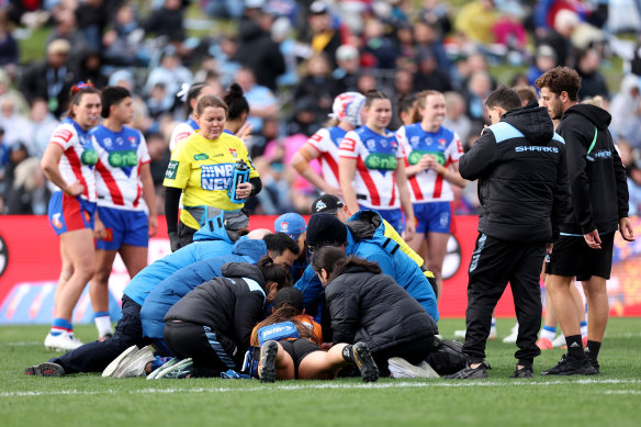 Talei Holmes is stretchered off after going head first into the ground.