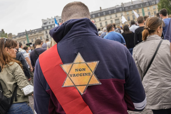 A star that reads “not vaccinated” is attached to the back of an anti-vaccine protester during a rally in Paris on Saturday.
