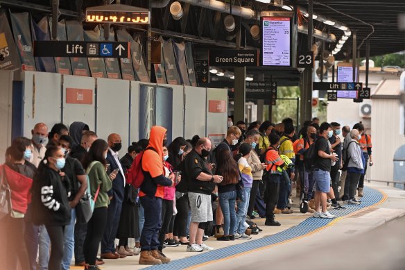 Commuters wait for the train at Central station as strike action causes significant delays across the network.